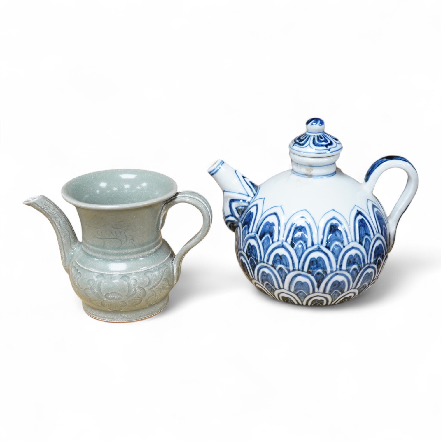 A Chinese blue and white teapot and cover, Xuande mark but later and a Chinese celadon glazed jug, tallest 13.5cm
